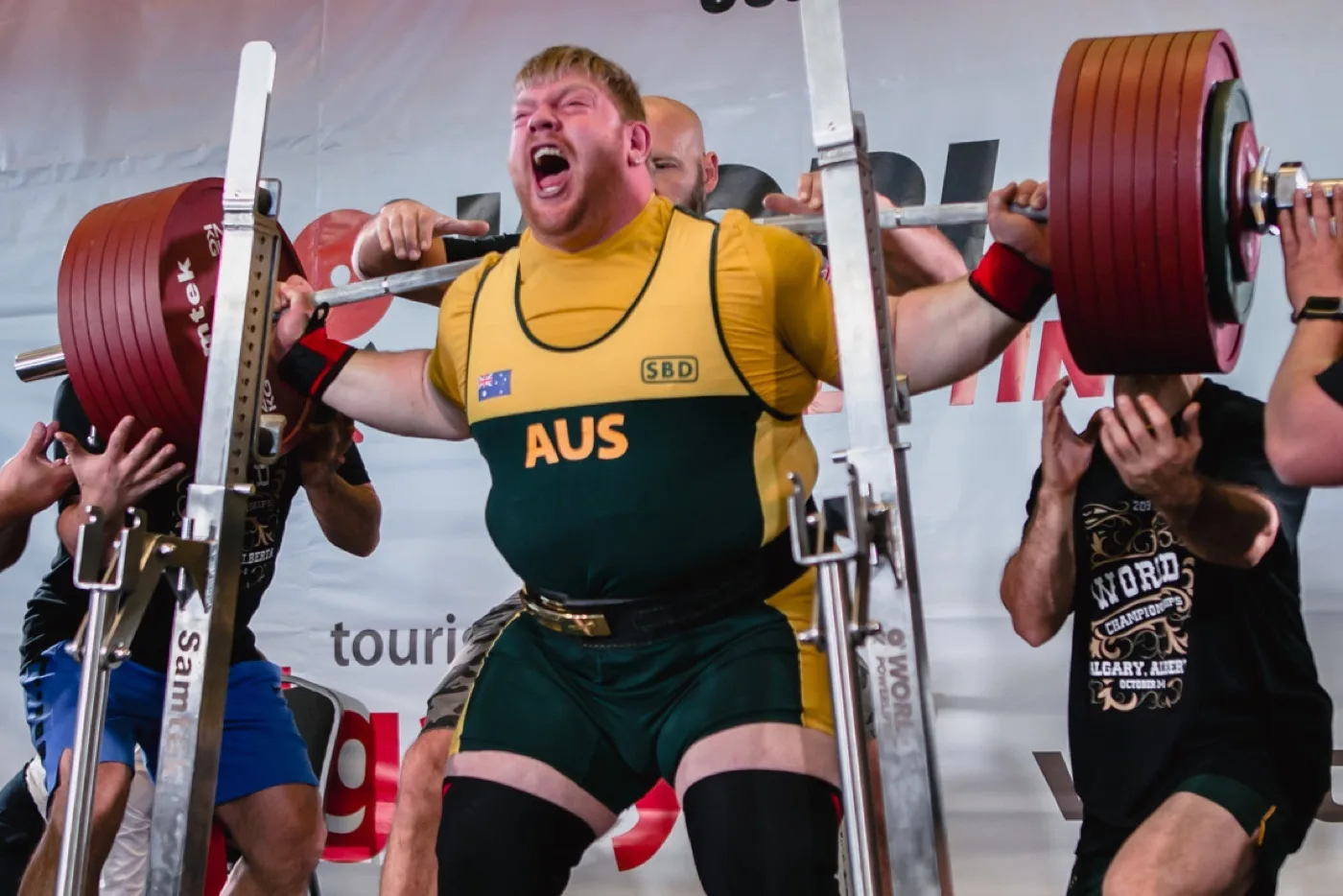 Powerlifter squatting on a competition platform
